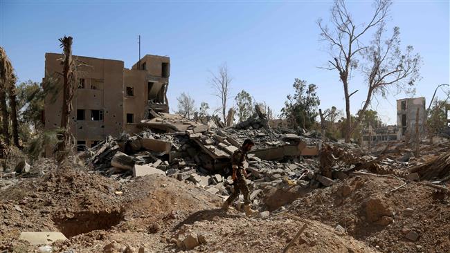 A member of the Syrian Democratic Forces (SDF) walks amid the rubble in the suburb of Dariya, on the western limits of Raqqah, Syria, June 27, 2017. (Photo by AFP)
