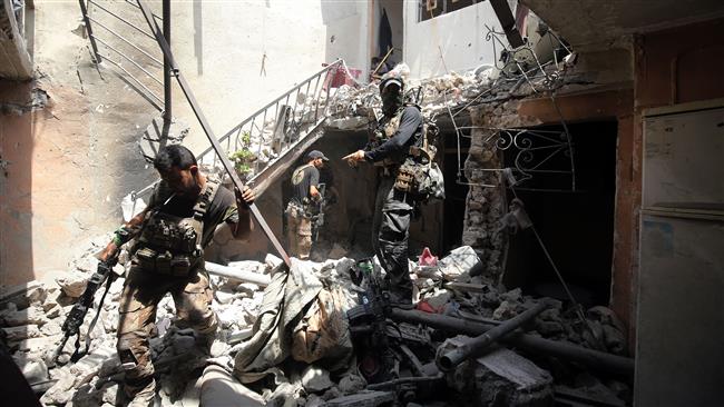 Iraqi Counter-Terrorism Service (CTS) forces take position inside a house in the Maidan district in Mosul