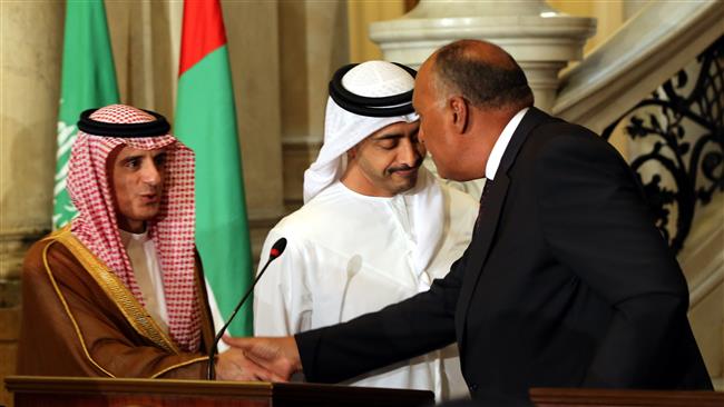 Egyptian Foreign Minister Sameh Shoukry (R) shakes hands with his Saudi counterpart Adel al-Jubeir (R) as UAE Minister of Foreign Affairs and International Cooperation Abdullah bin Zayed Al Nahyan stands by, during a joint press conference after their meeting in the Egyptian capital Cairo, July 5, 2017. (Photo by AFP)