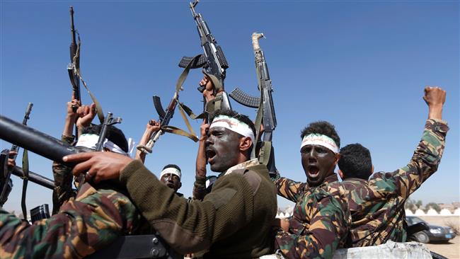 Houthi fighters chant slogans as they ride a military vehicle during a gathering in the capital Sana