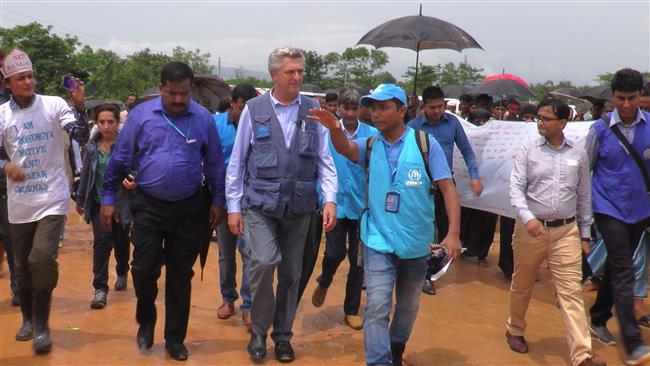 United Nations High Commissioner for Refugees Filippo Grandi (3L) walks during a visit to a Rohingya refugee camp in the Bangladeshi city of Cox