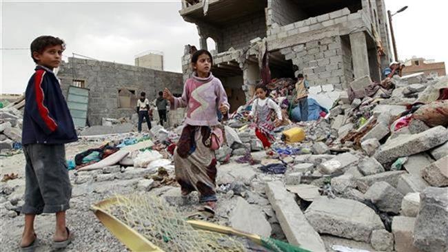 Yemeni children stand amid the rubble of a building damaged in an airstrike by the Saudi army on the capital Sana’a on July 13, 2015. (Photo by AFP)
