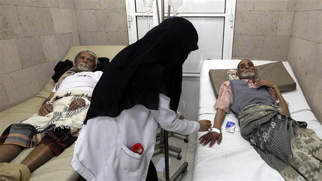 Yemeni men suspected of being infected with cholera receive treatment at a makeshift hospital in Sana