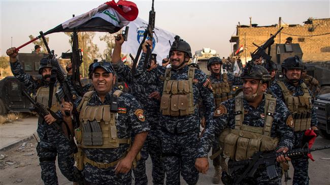 Iraqi federal police forces celebrate in the Old City of Mosul on July 10, 2017 after the government
