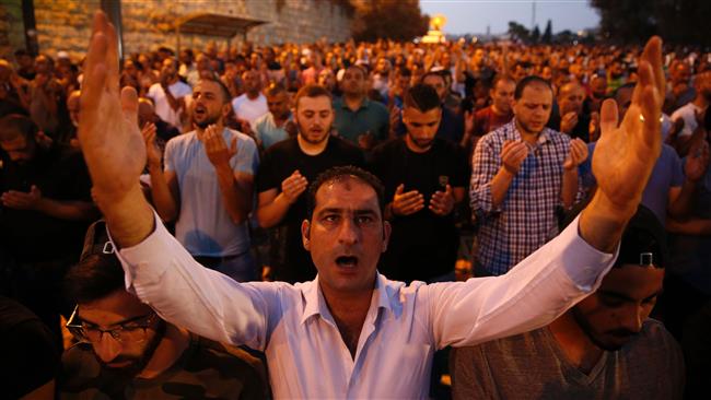 Palestinian Muslim worshippers pray outside Lions
