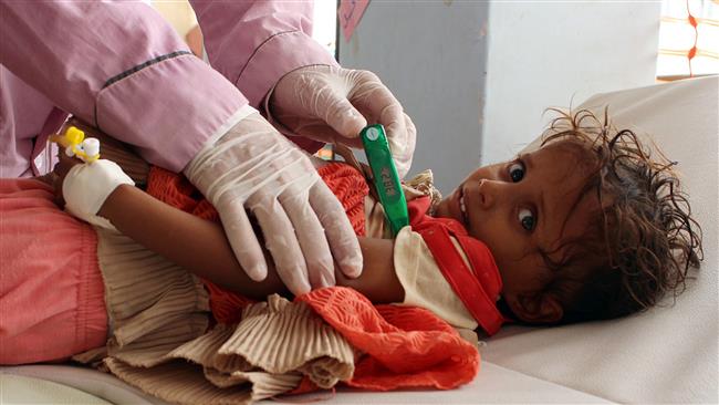 A Yemeni child suspected of being infected with cholera is checked by a doctor at a makeshift hospital operated by Doctors Without Borders (MSF) in the northern district of Abs in Yemen