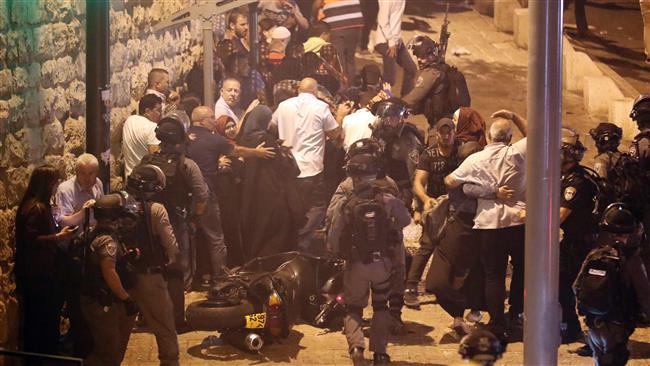 Israeli border guards attempt to disperse Palestinian Muslim worshipers outside Lions