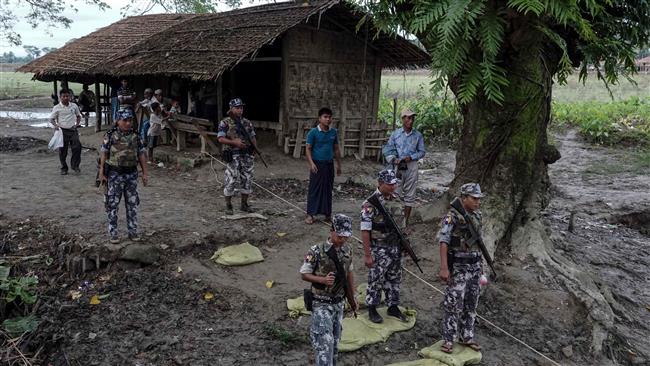 This photo taken on July 14, 2017 shows border police standing guard at Ngayantchaung village, Buthidaung township in Myanmar. (By AFP)