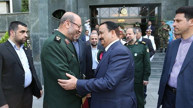 Iranian Defense Minister Brigadier General Hossein Dehqan (L) shakes hands with his Iraqi counterpart Erfan al-Hiyali in Tehran on July 22, 2017. (Photo by Tasnim news agency)