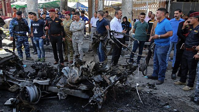 Iraqi security forces and civilians inspect the site of a deadly bomb attack, in Baghdad, Iraq, on May 30, 2017. (Photo by AFP)