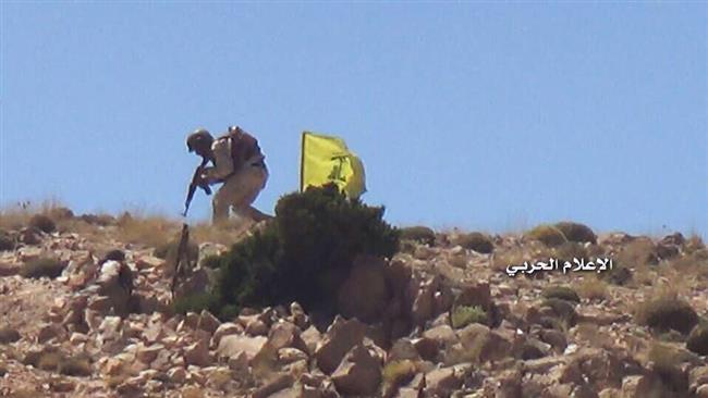 The picture released by the media bureau of Hezbollah Operations Command on July 23, 2017 shows a Hezbollah fighters advancing next to the group