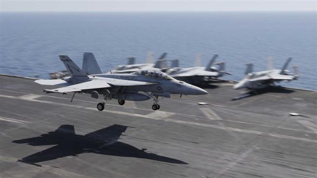 In this file photo, a US plane lands on the flight deck of the USS Theodore Roosevelt aircraft carrier, deployed to strike Daesh targets in Syria and Iraq. (Photo by Reuters)