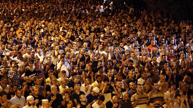 Palestinian Muslim worshippers pray outside Lions