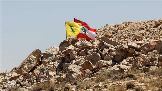 The photo shows the flags of Lebanon and Hezbollah flying in a mountainous area around the Lebanese border town of Arsal on July 26, 2017. (By AFP)