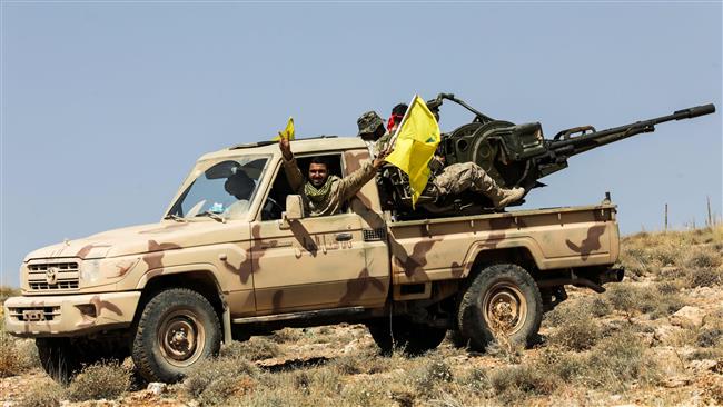 A picture taken on July 26, 2017 shows Hezbollah members manning an anti-aircraft gun mounted on a pick-up truck in a mountainous area around Arsal. (Photo by AFP)
