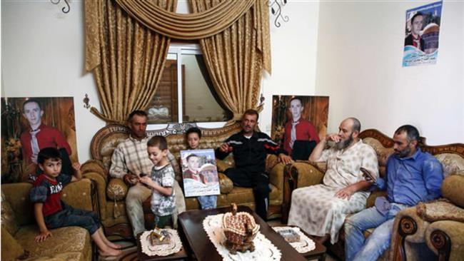 A picture taken on July 30, 2017 shows the family of Abdel Fattah al-Sharif, a 21-year-old Palestinian who was shot by Israeli soldier Elor Azaria in March 2016 in the occupied West Bank city of al-Khalil (Hebron). (Photo by AFP)
