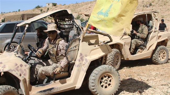 A picture taken on July 29, 2017 during a tour guided by the Lebanese Hezbollah resistance movement shows fighters of the group sitting in all-terrain-vehicles in the mountainous Juroud Arsal area around the Lebanese town of Arsal along the border with Syria. (Photo by AFP)
