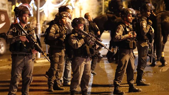 Israeli security forces stand guard as Palestinian worshipers pray outside Lion