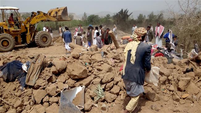 A loader clears the rubble as Yemenis gather at the site of a Saudi airstrike on the outskirts of the northwestern city of Sa’ada on August 4, 2017. (Photo by AFP)
