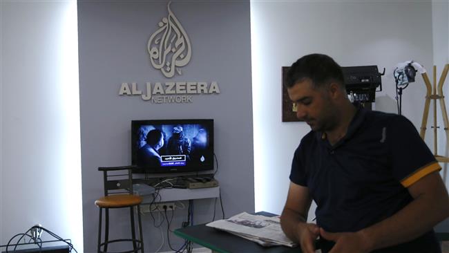 An employee of the Qatar-based news network and TV channel Al Jazeera is seen at the channel