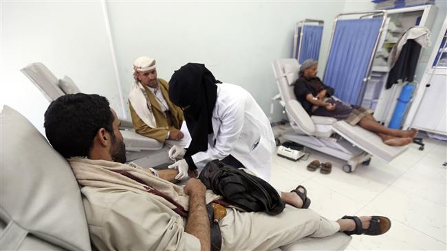 A Yemeni nurse gives medical treatment to a man donating blood at a transfusion center in the capital Sana