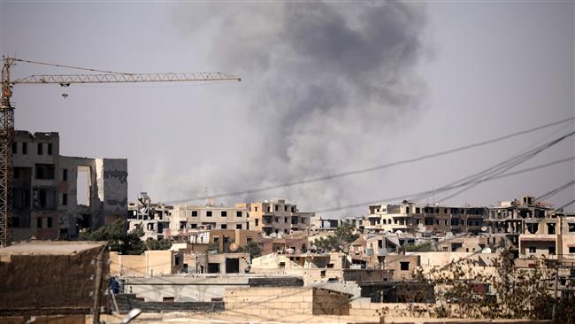 Smoke rises from a building in Raqqah, Syria, July 31, 2017. (Photo by Reuters)