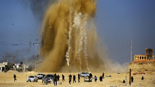 A file photo showing Palestinians running for cover as smoke rises following an Israeli air strike in northern Gaza. (Photo by AFP)
