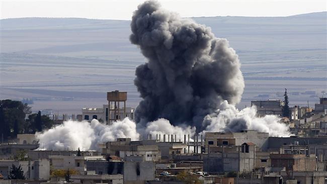 In this file photo, an explosion rocks the Syrian city of Kobani following a US-led airstrike. (Photo by Reuters)