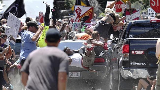 A Dodge Challenger (pictured) plows into counter protesters, killing one woman and hospitalizing 19 others. (Photo by AP)
