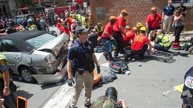 A woman  receives first-aid after a car ran into a crowd of protesters in Charlottesville, Virginia, on August 12, 2017. (Photo by AFP) 
