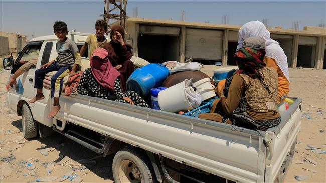 Internally displaced people, who fled Raqqah, sit in a truck during the fighting with Daesh terrorists in Raqqah, Syria, on August 14, 2017. (Photo by Reuters)
