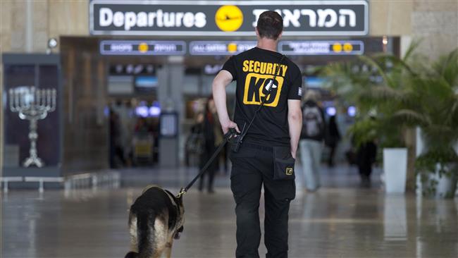 An Israeli airport guard patrols with a dog in Ben Gurion airport near Tel Aviv, March 22, 2016. (Photo by AP)
