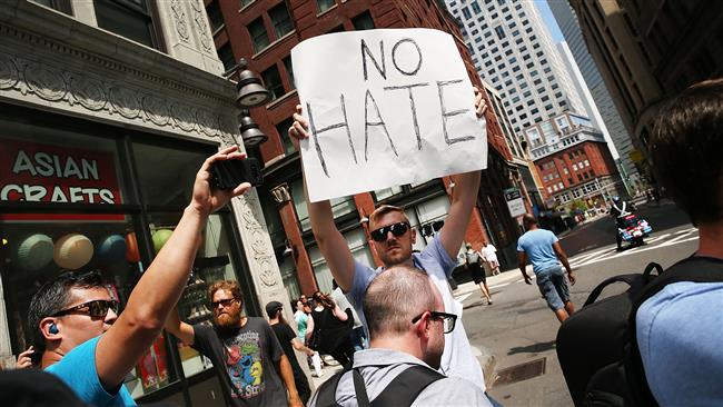 A protester holds a sign following a march in Boston, August 19, 2017. (Photo by AFP)
