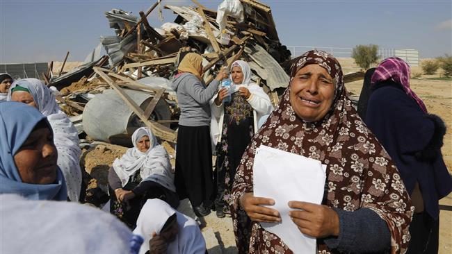 Palestinian Bedouin women react to the destruction of houses in the village of Umm al-Hiran, near the city of Beersheba, in the Negev Desert, on January 18, 2017. (Photo by AFP)
