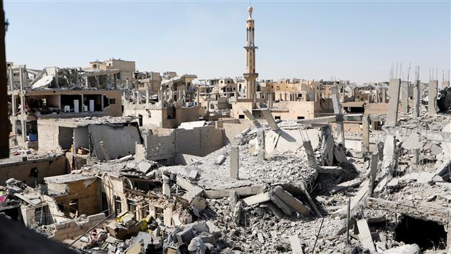 Buildings damaged in US-led airstrikes against the militant-held northern Syrian city of Raqqah are pictured on August 19, 2017 as fighting continues between US-backed militiamen from the so-called Syrian Democratic Forces (SDF) and Daesh Takfiri militants. (Photo by Reuters)
