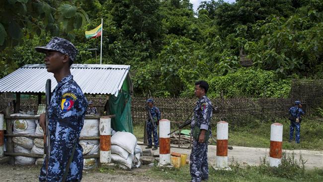 Myanmar border police stand guard at the check point near the entrance of Maungdaw township in Myanmar