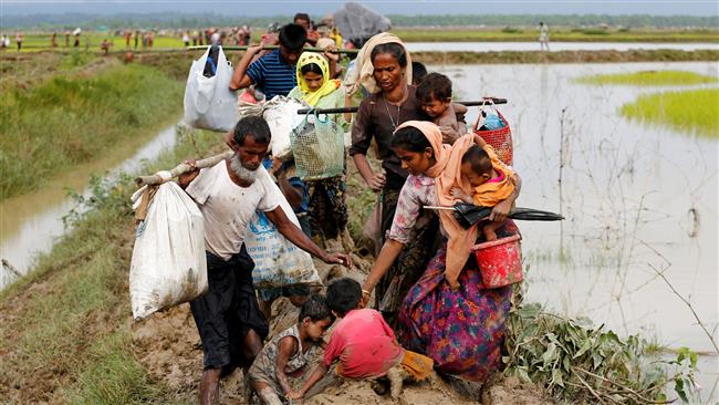 Children fall down as a group of Rohingya Muslim refugee people walk on the muddy path after crossing the Bangladesh-Myanmar border in Teknaf, Bangladesh, September 1, 2017. (Photo by Reuters)
