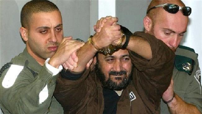 The file photo shows Palestinian Fatah Movement’s leader, Marwan Barghouti (C).
