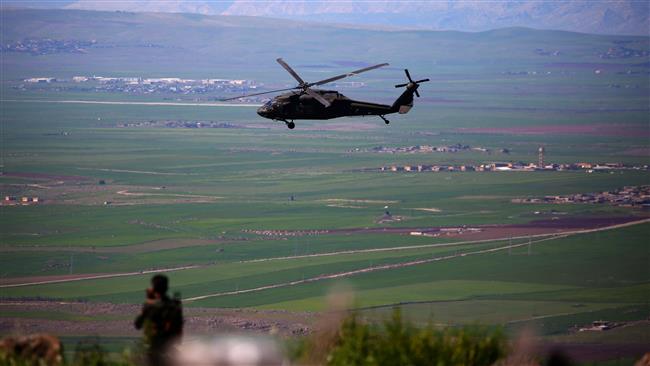 A US helicopter flies near the Syrian town of al-Malikiyah on April 25, 2017. (Photo by AFP)
