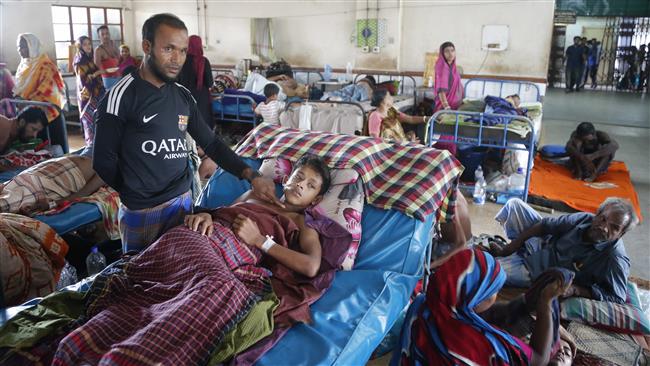 A Rohingya man points to the bullet wound his son sustained in Myanmar, as he receives treatment after crossing over the border into Bangladesh, at Chittagong Medical College Hospital in Chittagong, September 8, 2017. (Photo by AP)
