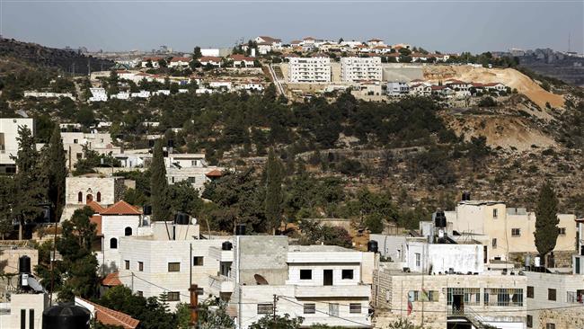 A picture taken on July 10, 2017 from the Palestinian village of Jania, west of Ramallah, in the Israeli-occupied West Bank, shows the Jewish settlement of Talmon appearing in the background. (By AFP)
