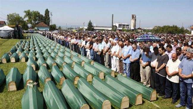 Bosnian Muslims, survivors of Srebrenica 1995 massacre pray near body caskets of their relatives, laid out at memorial cemetery in village of Potocari, near Eastern-Bosnian town of Srebrenica, on July 11, 2016. (Photo by AFP)
