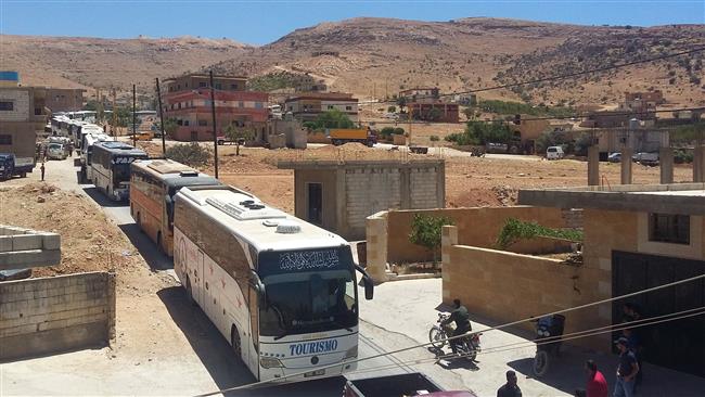 This photo taken on July 31, 2017, shows a convoy of Syrian militants and their families entering Lebanon’s Wadi al-Hamid area in the border region of Jurud Arsal to be transported to Syria