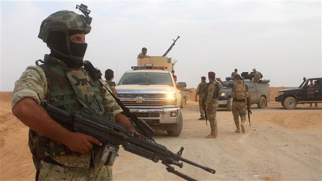 Iraqi forces are seen outside the town of Akashat, northwest of Anbar province, on September 15, 2017 as they prepare for a military operation to push out Daesh Takfiri terrorists from nearby areas. (Photo by AFP)