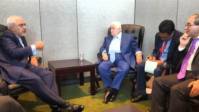 Iranian Foreign Minister Mohammad Javad Zarif (L) and his Syrian counterpart Walid al-Moualem (3rd R) meet in New York on September 22, 2017.
