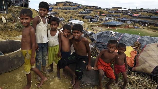 Rohingya refugee children sit next to makeshift shelters at the refugee camp of Balukhali near the locality of Ukhia, Bangladesh, on September 22, 2017. (Photo by AFP)
