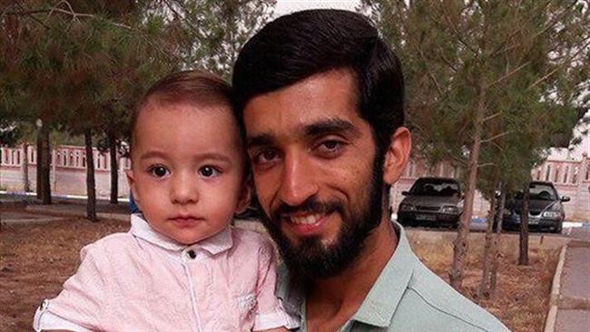 Martyred Iranian military advisor Mohsen Hojaji and his son
