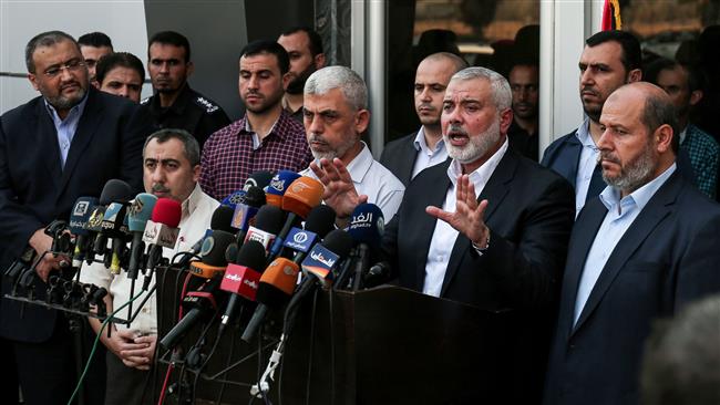 Hamas Chief Ismail Haniyeh (2nd from R) speaks to the press upon his arrival on the Rafah border crossing, in the southern Gaza Strip, on September 19, 2017. (Photo by AFP)
