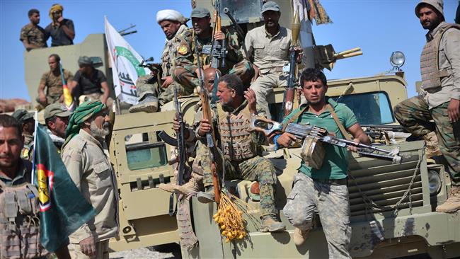 Iraqi pro-government fighters from Popular Mobilization Units (Hashd al-Sha’abi) carry their weapons in al-Fateha military airport south of Hawijah, Iraq, on October 2, 2017. (Photo by Reuters)
