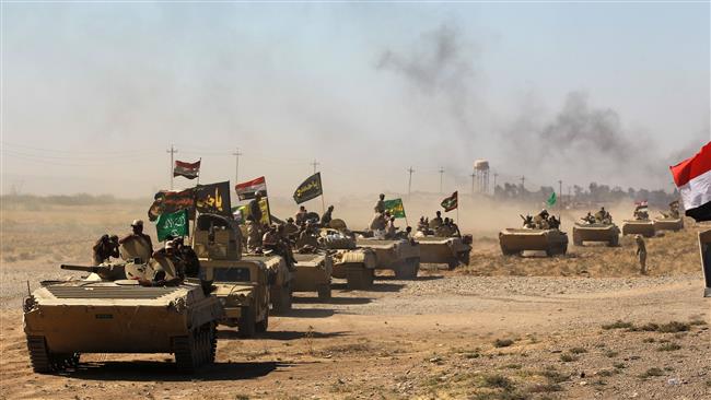 Iraqi forces and fighters from the Popular Mobilization Units (Hashd al-Sha’abi) advance towards the Daesh stronghold of Hawijah on October 4, 2017, during an operation to recapture the town from the militants.
